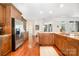 Kitchen featuring granite countertops, stainless steel appliances, wooden cabinets, and hardwood floors at 1849 Oakmont Dr, Denver, NC 28037