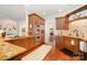 Kitchen featuring granite countertops, wooden cabinets, stainless steel double ovens, and hardwood floors at 1849 Oakmont Dr, Denver, NC 28037
