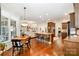 Open floor plan from the kitchen to dining and living rooms with wood floors and a large island with seating at 1849 Oakmont Dr, Denver, NC 28037
