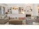 Comfortable living room with a fireplace, built-in bookcases, hardwood floors, and ample seating space at 1849 Oakmont Dr, Denver, NC 28037