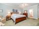 Spacious primary bedroom with ceiling fan, carpet, and ensuite bathroom entrance at 1849 Oakmont Dr, Denver, NC 28037