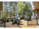 Inviting outdoor patio with dining set and grill, surrounded by lush trees for a peaceful retreat at 1849 Oakmont Dr, Denver, NC 28037