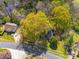 Aerial view displays the home nestled among trees, with convenient access to roads and nearby parking areas at 1903 Marshall Ave, Gastonia, NC 28052