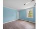 Bright bedroom with light wood floors, blue walls, and natural light at 1903 Marshall Ave, Gastonia, NC 28052
