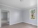 A bright bedroom with light gray walls, white trim, and wood-look floors at 1903 Marshall Ave, Gastonia, NC 28052