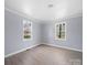 Bedroom featuring light gray walls, white trim, and wood-look flooring at 1903 Marshall Ave, Gastonia, NC 28052