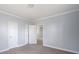 Bedroom with light wood floors, three doors and neutral paint at 1903 Marshall Ave, Gastonia, NC 28052