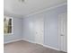Bedroom featuring light gray walls, white trim and doors, and wood-look flooring at 1903 Marshall Ave, Gastonia, NC 28052