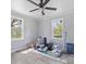 Bedroom with light wood floors, two windows, and ceiling fan at 1903 Marshall Ave, Gastonia, NC 28052