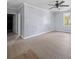 Bright bedroom featuring light wood floors, ceiling fan, and natural light from window at 1903 Marshall Ave, Gastonia, NC 28052