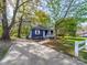 Inviting blue house featuring a cozy front porch and a concrete driveway at 1903 Marshall Ave, Gastonia, NC 28052