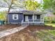 Charming blue house with white trim, covered porch, and well-maintained landscaping at 1903 Marshall Ave, Gastonia, NC 28052