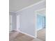 Bright hallway with light blue walls, white trim and doors, and wood-look flooring at 1903 Marshall Ave, Gastonia, NC 28052