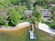 Aerial shot showcases a waterfront property with a private beach and boat dock at 19040 Mary Ardrey Cir, Cornelius, NC 28031