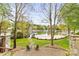 Scenic lake view from the backyard featuring a sandy beach and boat dock at 19040 Mary Ardrey Cir, Cornelius, NC 28031