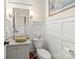 Chic powder room with stylish vanity, vessel sink, and decorative wall paneling for a touch of elegance at 19040 Mary Ardrey Cir, Cornelius, NC 28031