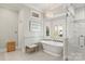 Spa-like bathroom with a freestanding tub, glass-enclosed shower, and elegant fixtures for a relaxing retreat at 19040 Mary Ardrey Cir, Cornelius, NC 28031