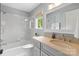 Bright bathroom with a tub-shower combo, a gray vanity, and classic fixtures at 19040 Mary Ardrey Cir, Cornelius, NC 28031