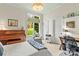 Bright bedroom featuring a grand piano, desk, comfortable sitting chair, and view of the landscaped outdoors at 19040 Mary Ardrey Cir, Cornelius, NC 28031