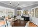 Charming dining room featuring a dark wood table with seating for six, complemented by decorative cabinets and stylish lighting at 19040 Mary Ardrey Cir, Cornelius, NC 28031