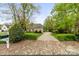 Charming home featuring a long driveway and beautifully maintained landscaping at 19040 Mary Ardrey Cir, Cornelius, NC 28031