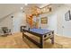 Spacious game room with a beautiful spiral staircase and table tennis, perfect for recreation and entertainment at 19040 Mary Ardrey Cir, Cornelius, NC 28031