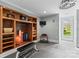 Well-equipped home gym with custom shelving, weights, and an exercise bench at 19040 Mary Ardrey Cir, Cornelius, NC 28031