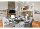 Spacious living room featuring a stone fireplace, tall ceilings, and natural light at 19040 Mary Ardrey Cir, Cornelius, NC 28031