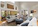 Bright living room with tall ceilings, a large round ottoman, and access to a patio at 19040 Mary Ardrey Cir, Cornelius, NC 28031