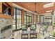 Spacious sunroom with stone fireplace, ceiling fans, and many windows overlooking water views at 19040 Mary Ardrey Cir, Cornelius, NC 28031