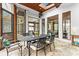 Bright sunroom with stone flooring, large windows, and an elegant dining set for enjoying meals with a view at 19040 Mary Ardrey Cir, Cornelius, NC 28031