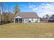 Spacious backyard featuring a patio with grill, fire pit, and screened porch at 2017 Autumn Dr, Monroe, NC 28110