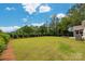 Expansive green backyard, with trees and manicured hedges for ultimate privacy at 2017 Autumn Dr, Monroe, NC 28110