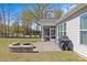 Inviting backyard with a brick patio, fire pit, grill, and screened-in porch, ideal for entertaining at 2017 Autumn Dr, Monroe, NC 28110
