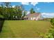 Spacious, well-manicured backyard featuring a black fence, lush grass, and a charming patio area at 2017 Autumn Dr, Monroe, NC 28110