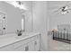Bathroom featuring a spacious vanity with modern fixtures, leading to a bedroom with stylish decor at 2017 Autumn Dr, Monroe, NC 28110