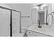 Clean bathroom featuring a glass-enclosed shower, toilet, sink, and mirror at 2017 Autumn Dr, Monroe, NC 28110