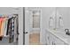 Bathroom view through a closet, showing a tub and shower and a sink with white cabinets at 2017 Autumn Dr, Monroe, NC 28110
