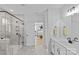 Bathroom showcasing glass shower, dual sink vanity, open doorway to the adjacent bedroom at 2017 Autumn Dr, Monroe, NC 28110