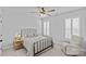 Bright bedroom features a ceiling fan, plantation shutters, and a cozy sitting area at 2017 Autumn Dr, Monroe, NC 28110