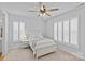 Serene bedroom with neutral carpet, a ceiling fan, and natural light coming through plantation shutters at 2017 Autumn Dr, Monroe, NC 28110