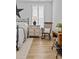 Cozy bedroom features wood floors, shuttered window, bedside table with lamp, and wooden rocking chair at 2017 Autumn Dr, Monroe, NC 28110