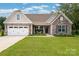 Charming single-Gathering home with stone accents, two-car garage, and well-maintained lawn at 2017 Autumn Dr, Monroe, NC 28110