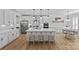 Spacious white kitchen with large island, stainless steel appliances, and modern lighting at 2017 Autumn Dr, Monroe, NC 28110