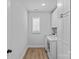 Bright laundry room with front-load washer and dryer and white cabinets at 2017 Autumn Dr, Monroe, NC 28110