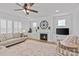 Cozy living room with a fireplace, plantation shutters, and a ceiling fan for comfortable living at 2017 Autumn Dr, Monroe, NC 28110
