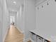 Well-lit mudroom with coat hooks, bench, and storage baskets at 2017 Autumn Dr, Monroe, NC 28110