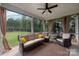 Relaxing screened porch with comfortable seating, ceiling fan, and backyard view at 2017 Autumn Dr, Monroe, NC 28110