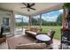 Inviting screened porch features comfortable seating and views of the backyard and fire pit at 2017 Autumn Dr, Monroe, NC 28110