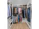 Spacious walk-in closet with custom shelves, hanging rods, and wood floor at 2017 Autumn Dr, Monroe, NC 28110